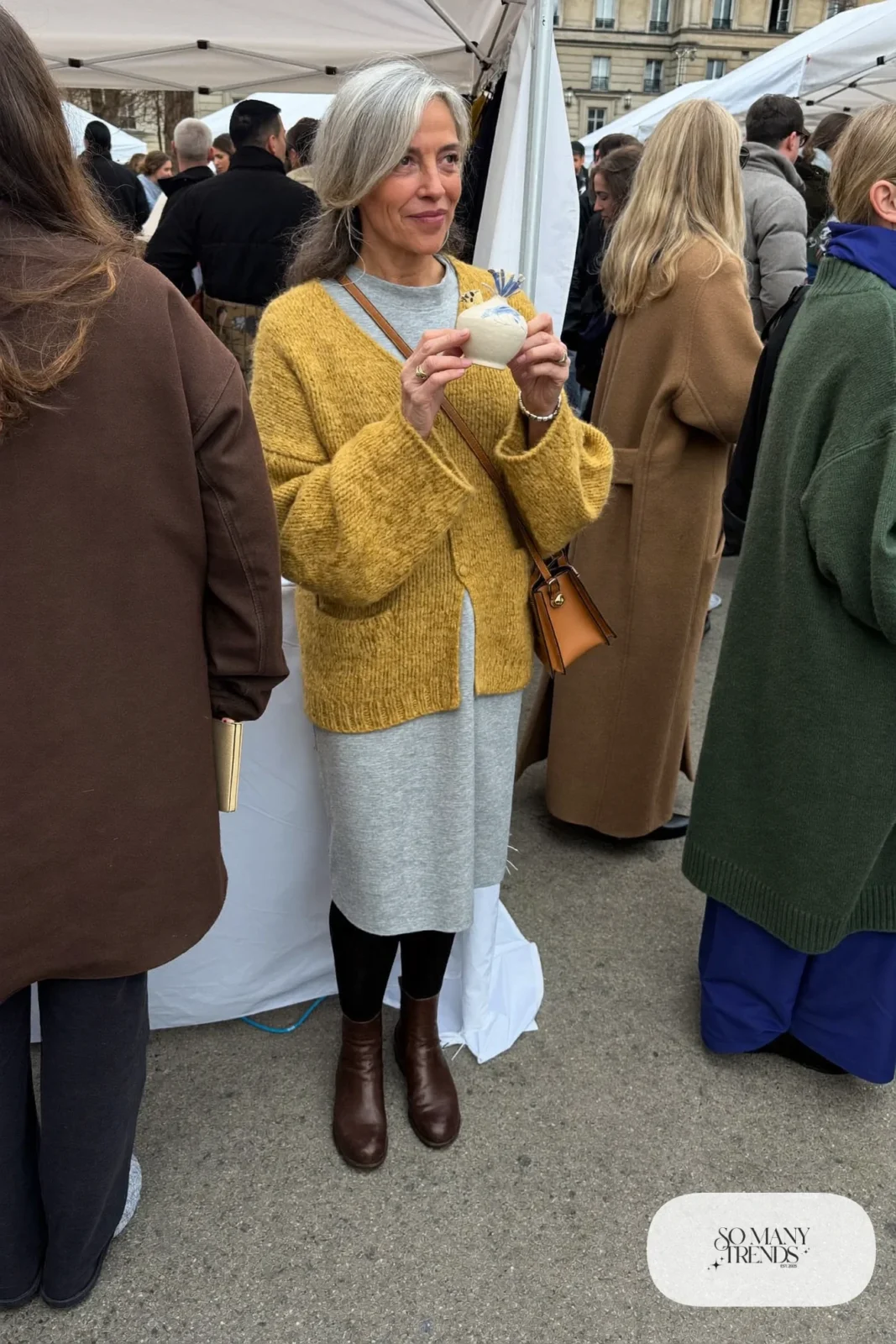 woman over 60 in mustard cardigan gray midi dress opaque tights ankle boots crossbody bag outfit 29