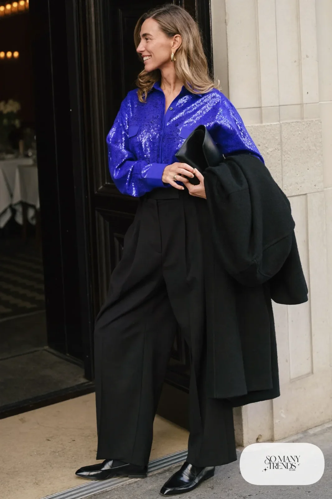 cobalt blue sequin button shirt black wide-leg pants black loafers black long coat gold hoops outfit 7
