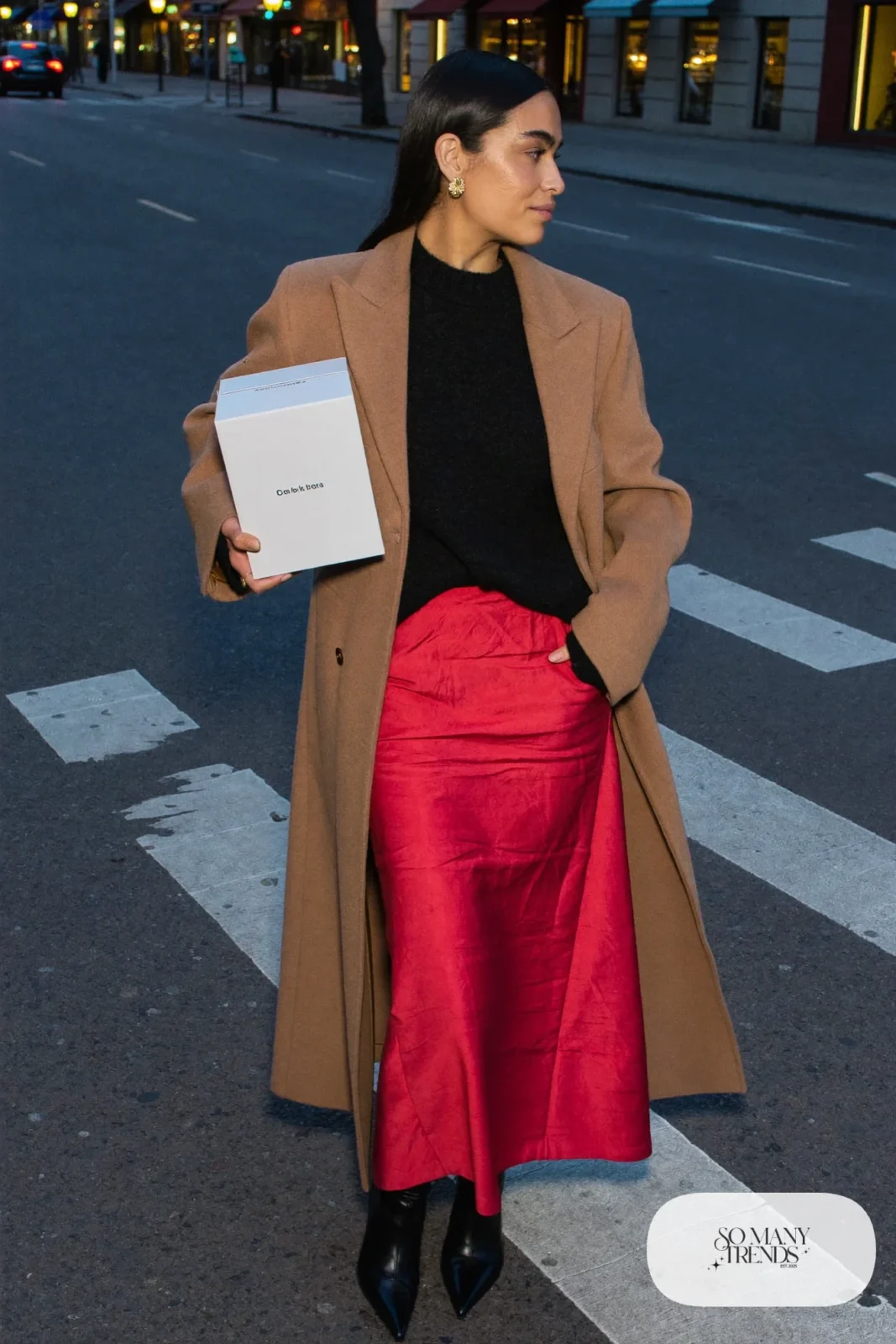 cherry red satin midi skirt black fine knit sweater black pointed boots camel coat gold earrings outfit 27