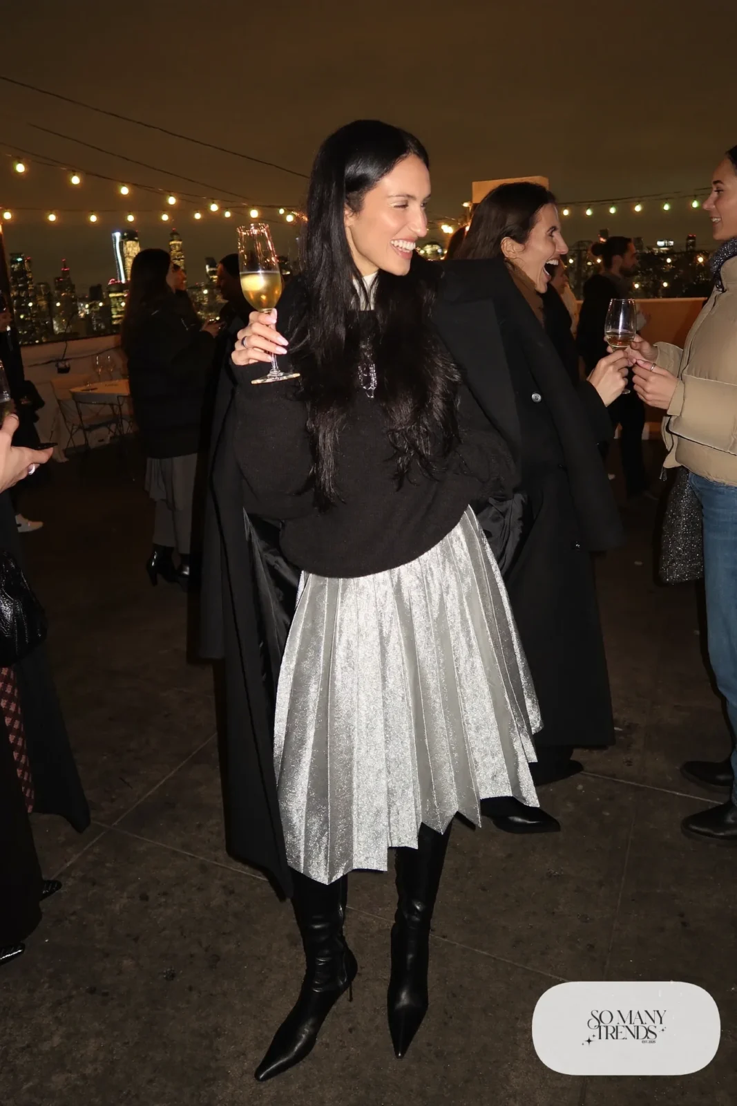 silver metallic pleated midi skirt black oversized sweater sheer black tights knee-high boots outfit 6