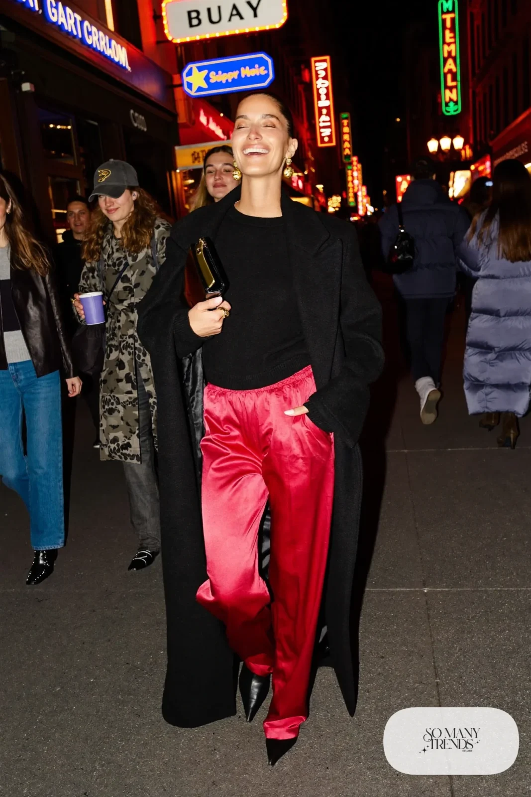 red satin wide-leg pants black fitted sweater long black coat pointed black boots gold earrings outfit 9