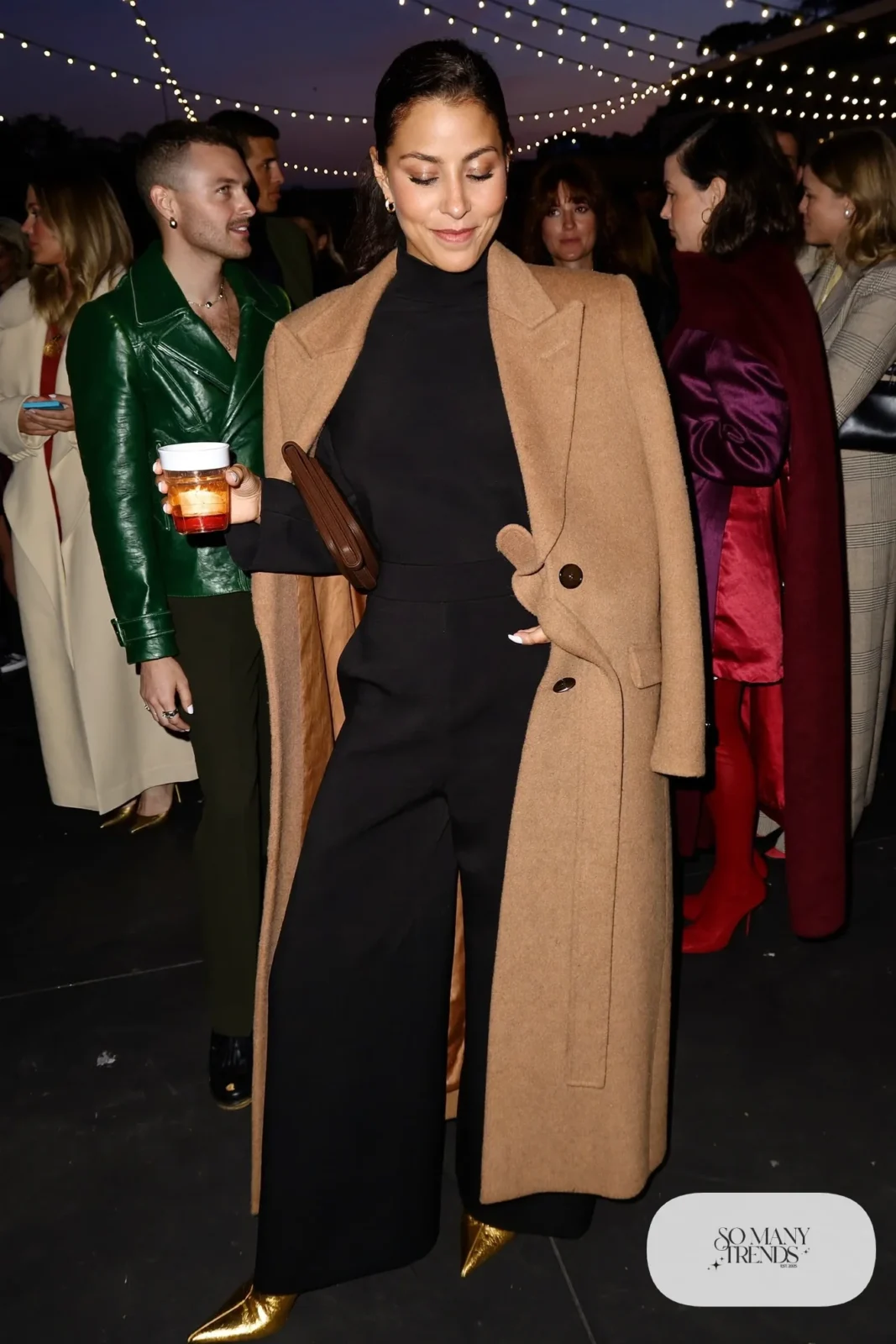 black long sleeve wide-leg jumpsuit camel belted wool coat metallic ankle boots outfit 10