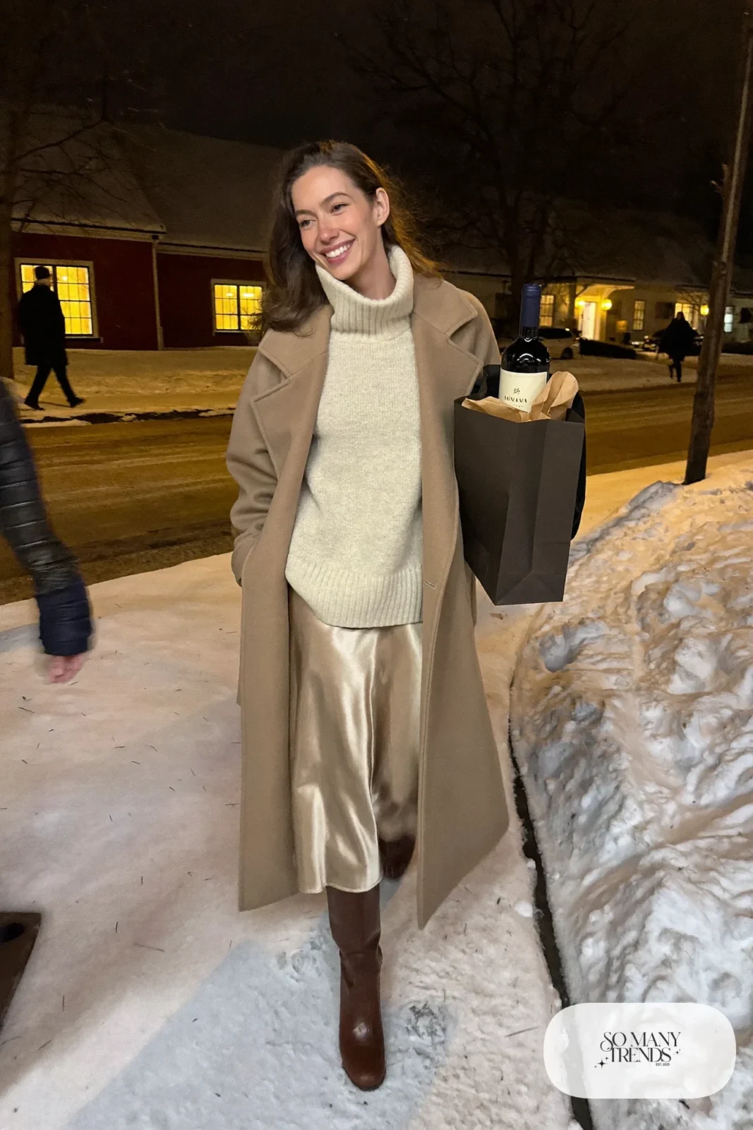 champagne satin midi skirt chunky cream turtleneck long camel coat tall brown boots outfit 13