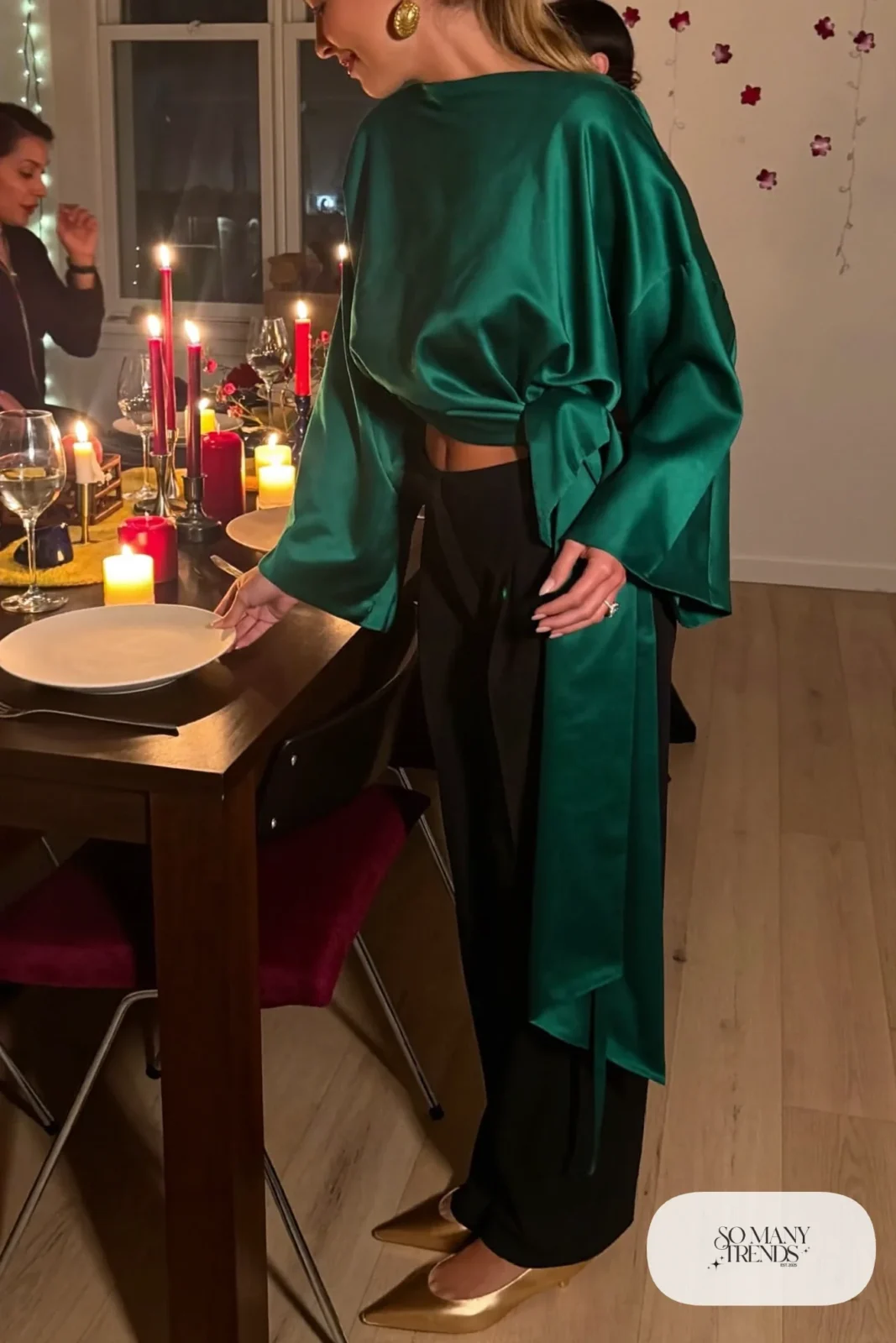 emerald satin wrap top black wide-leg pants gold flat sandals gold hoops outfit 14