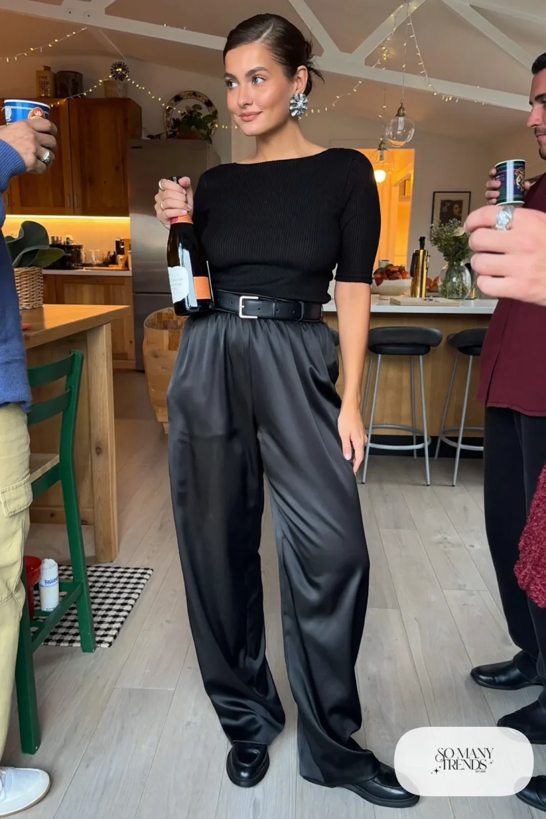 black ribbed knit top black satin wide-leg pants black leather belt silver earrings black loafers outfit 23
