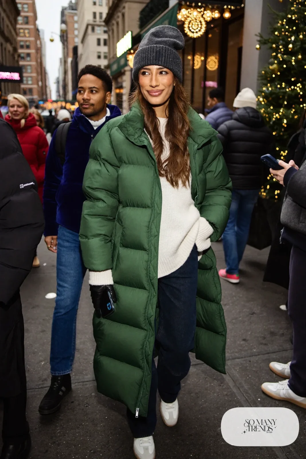 long forest green puffer coat ivory ribbed sweater dark straight jeans white leather sneakers beanie outfit 2