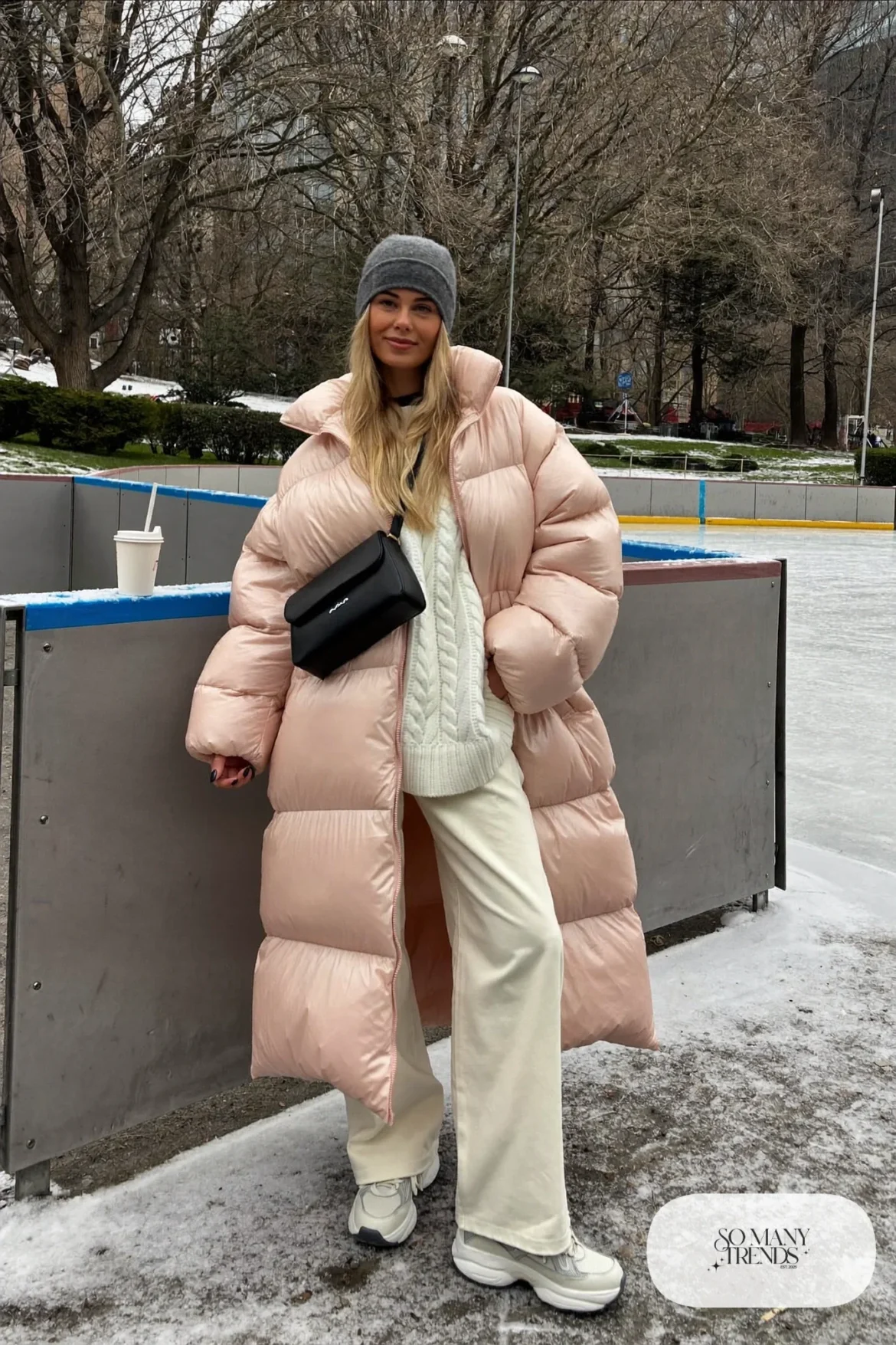 long blush pink puffer coat cream wide-leg pants white heavy knit sweater white waterproof sneakers gray beanie outfit 10