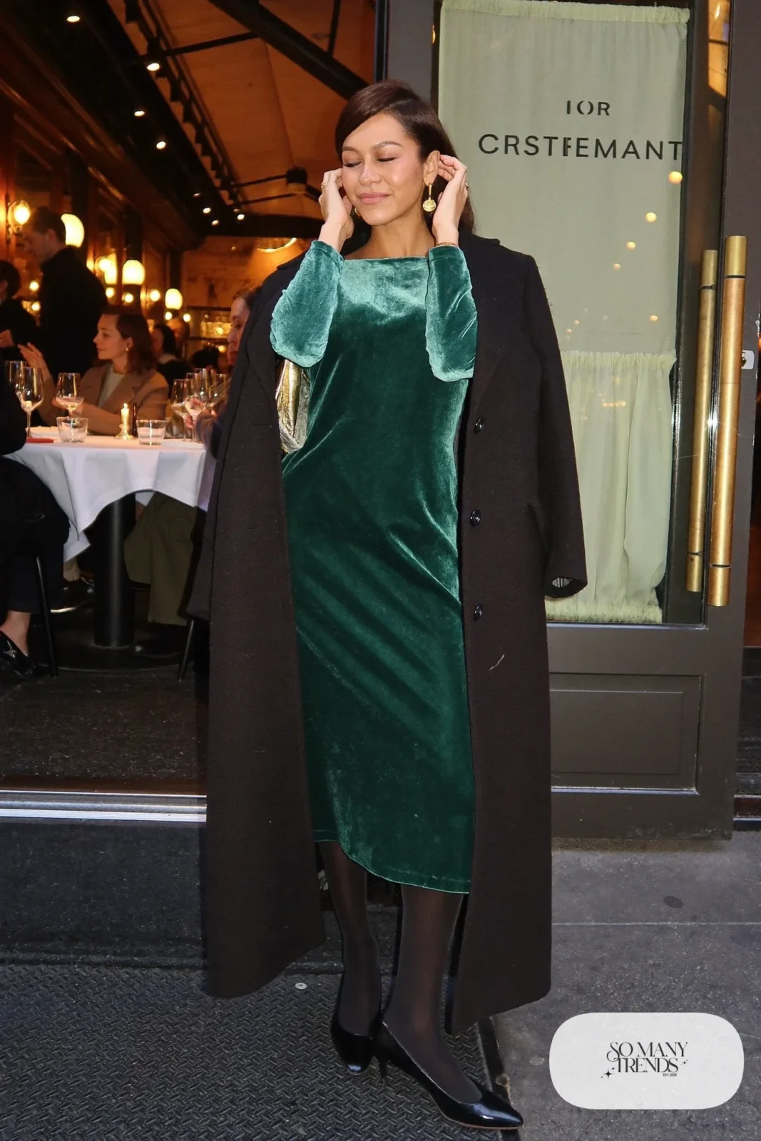 deep green velvet midi dress long sleeves sheer black tights black closed-toe pumps long black wool coat gold clutch outfit 20