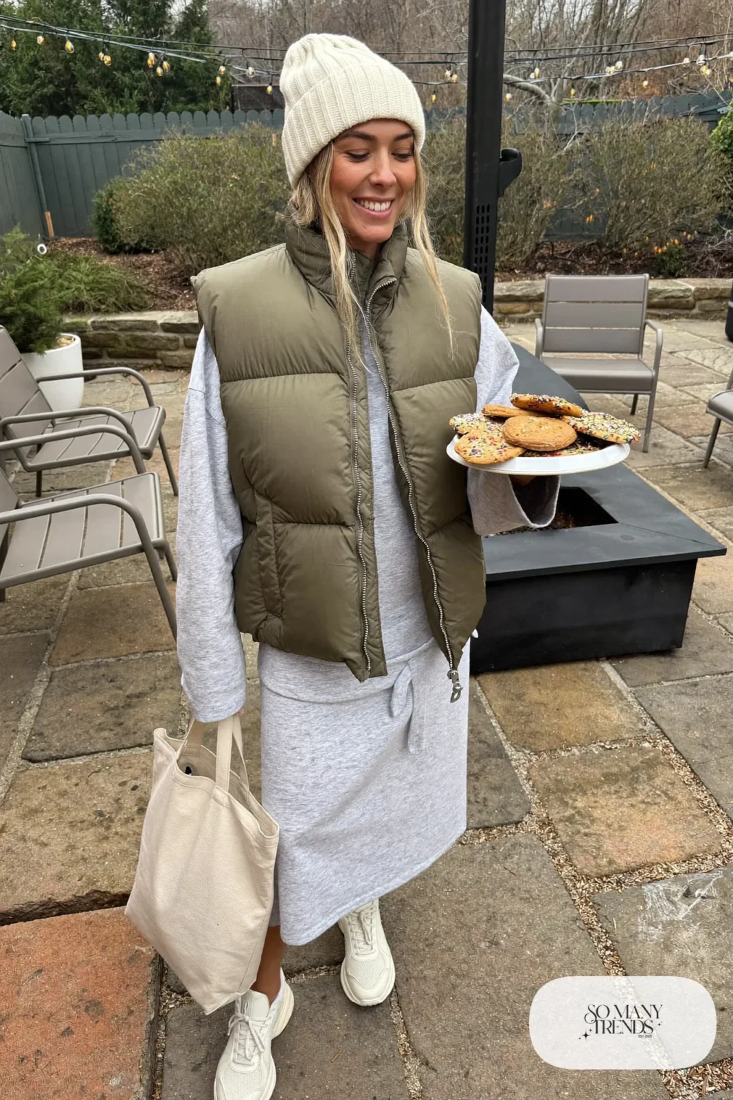 gray sweatshirt midi dress olive quilted puffer vest white chunky sneakers beanie outfit 11