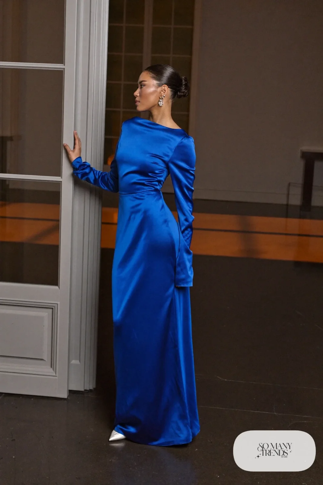 cobalt blue satin long-sleeve gown with silver drop earrings and silver closed-toe heels, formal winter outfit 8