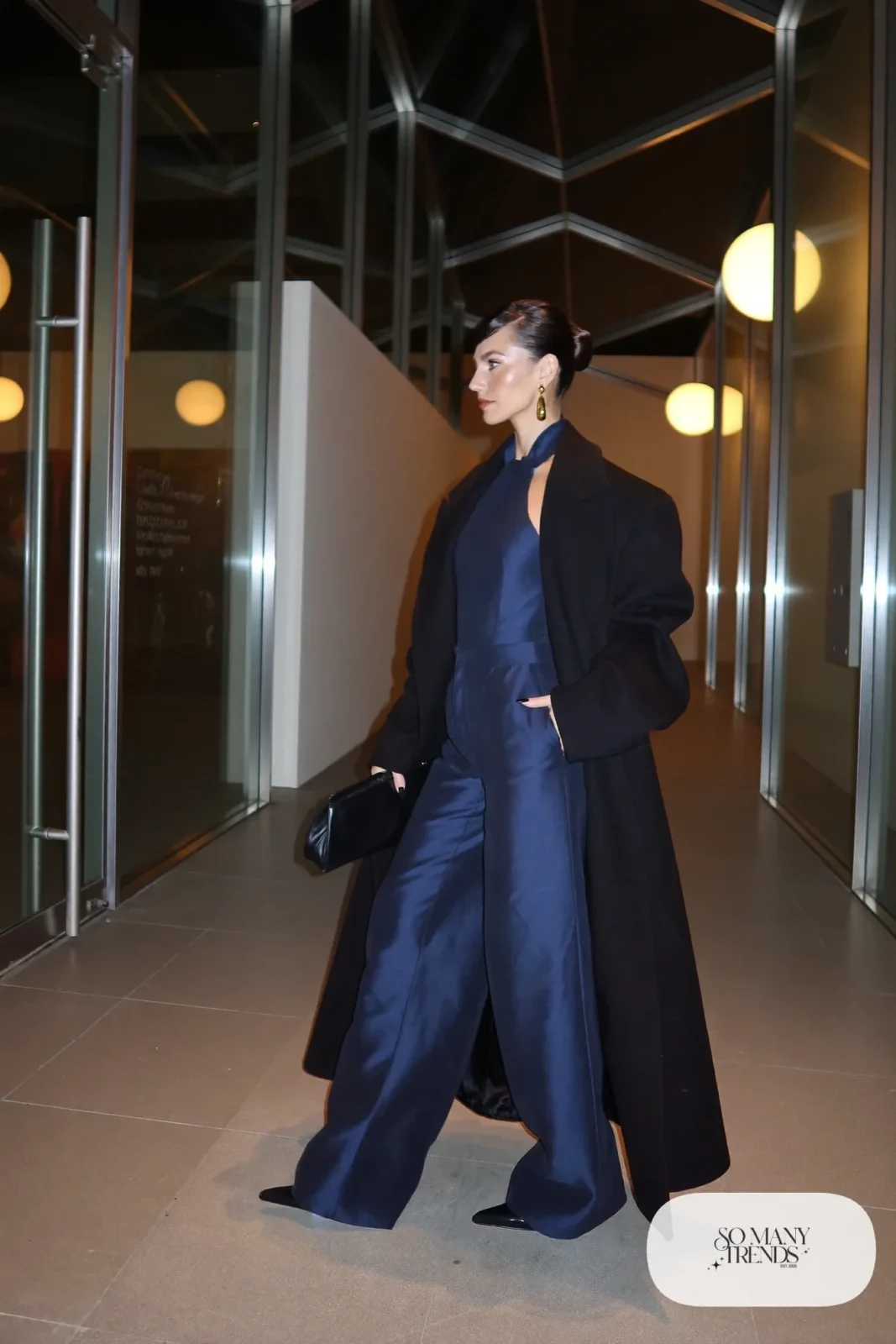 midnight navy satin wide-leg jumpsuit with black tailored coat, gold earrings and black pointed heels, formal winter outfit 15