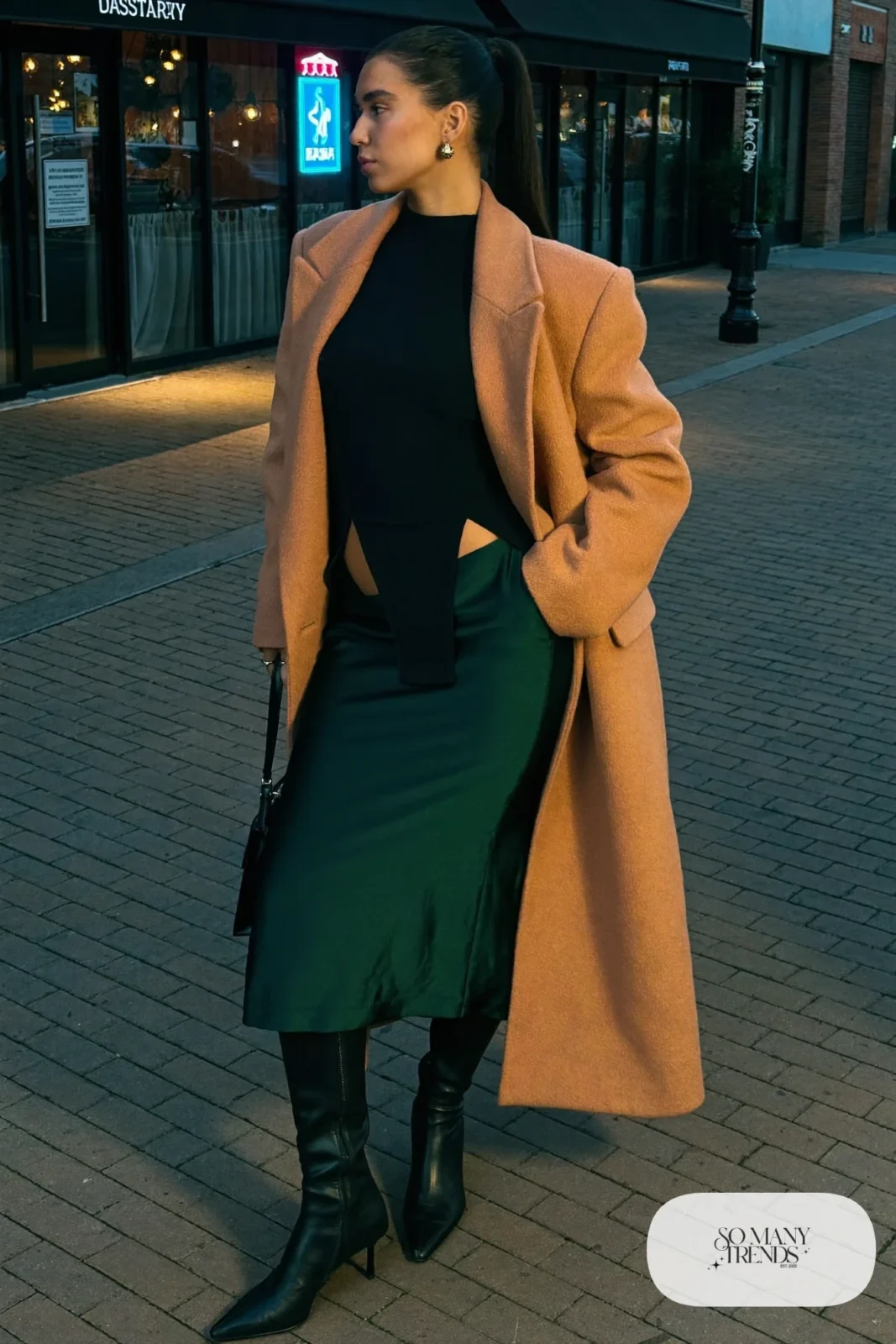forest green satin midi skirt with fitted black knit top, black knee-high leather boots and wool coat, formal winter outfit 19