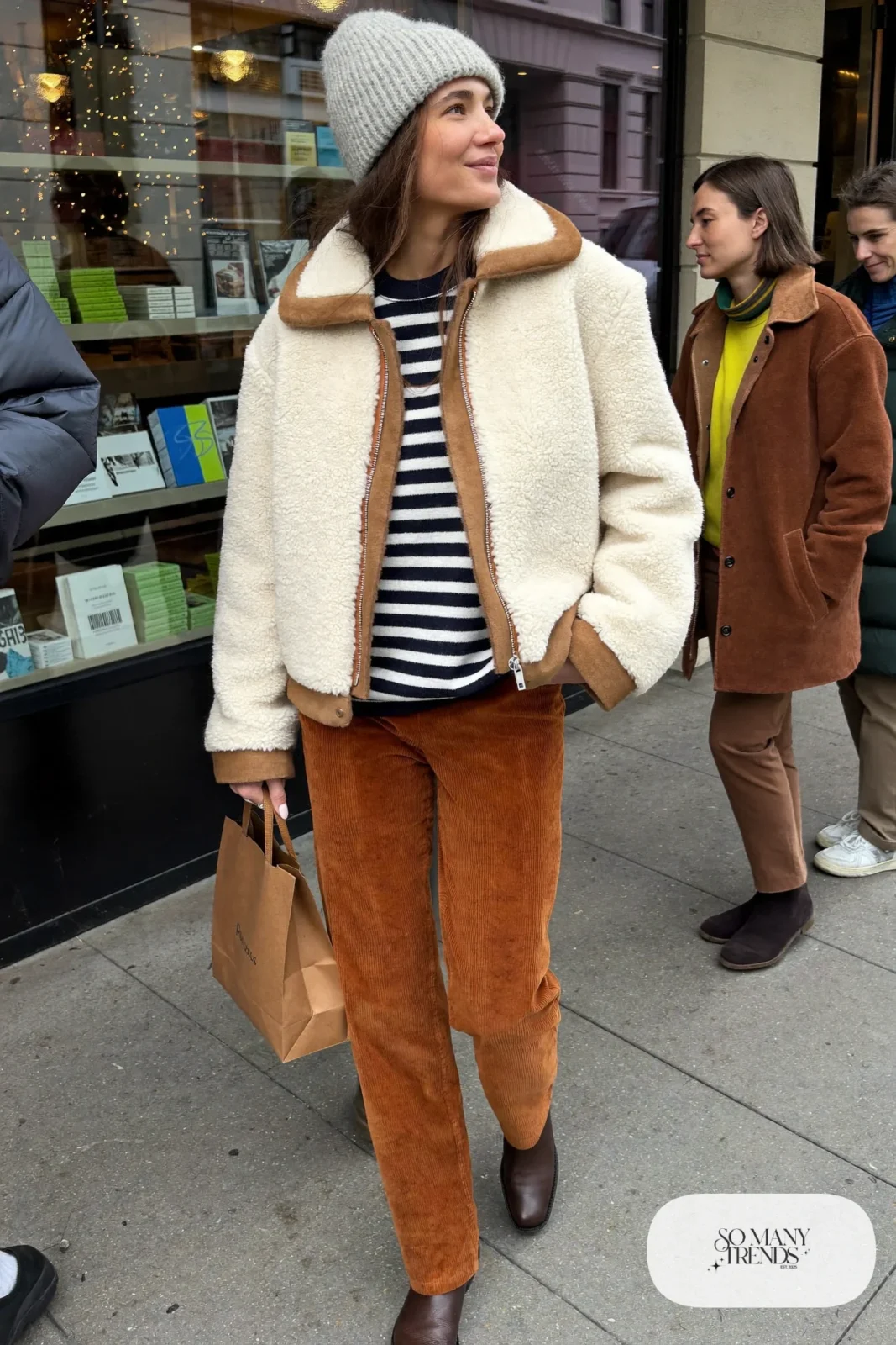 cream faux shearling boxy jacket rust corduroy straight pants striped top brown boots beanie outfit 9