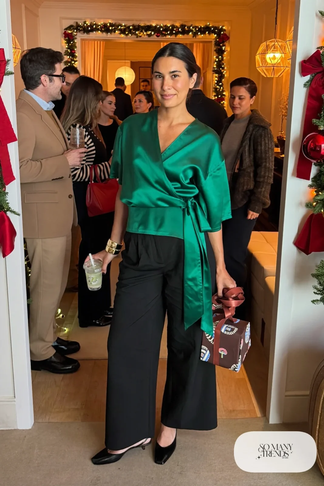 emerald satin wrap top black wide-leg pants closed-toe slingbacks gold cuff outfit 27