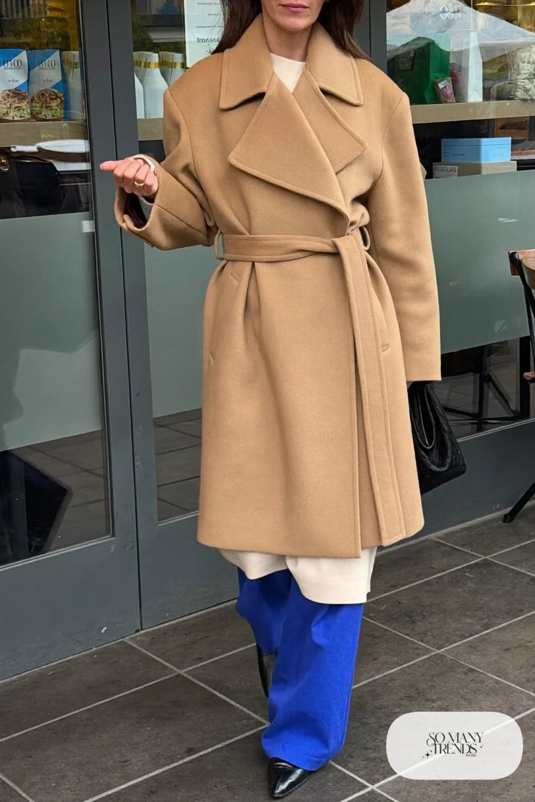 long camel wrap coat cobalt blue wide-leg pants cream knit top black pointed boots january outfit 15