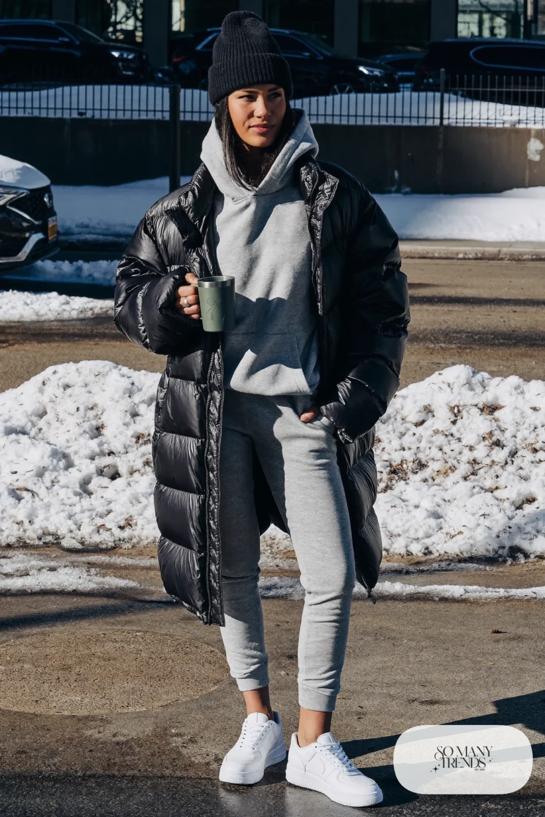 long black puffer coat gray oversized hoodie gray joggers white sneakers black beanie travel mug january outfit 16