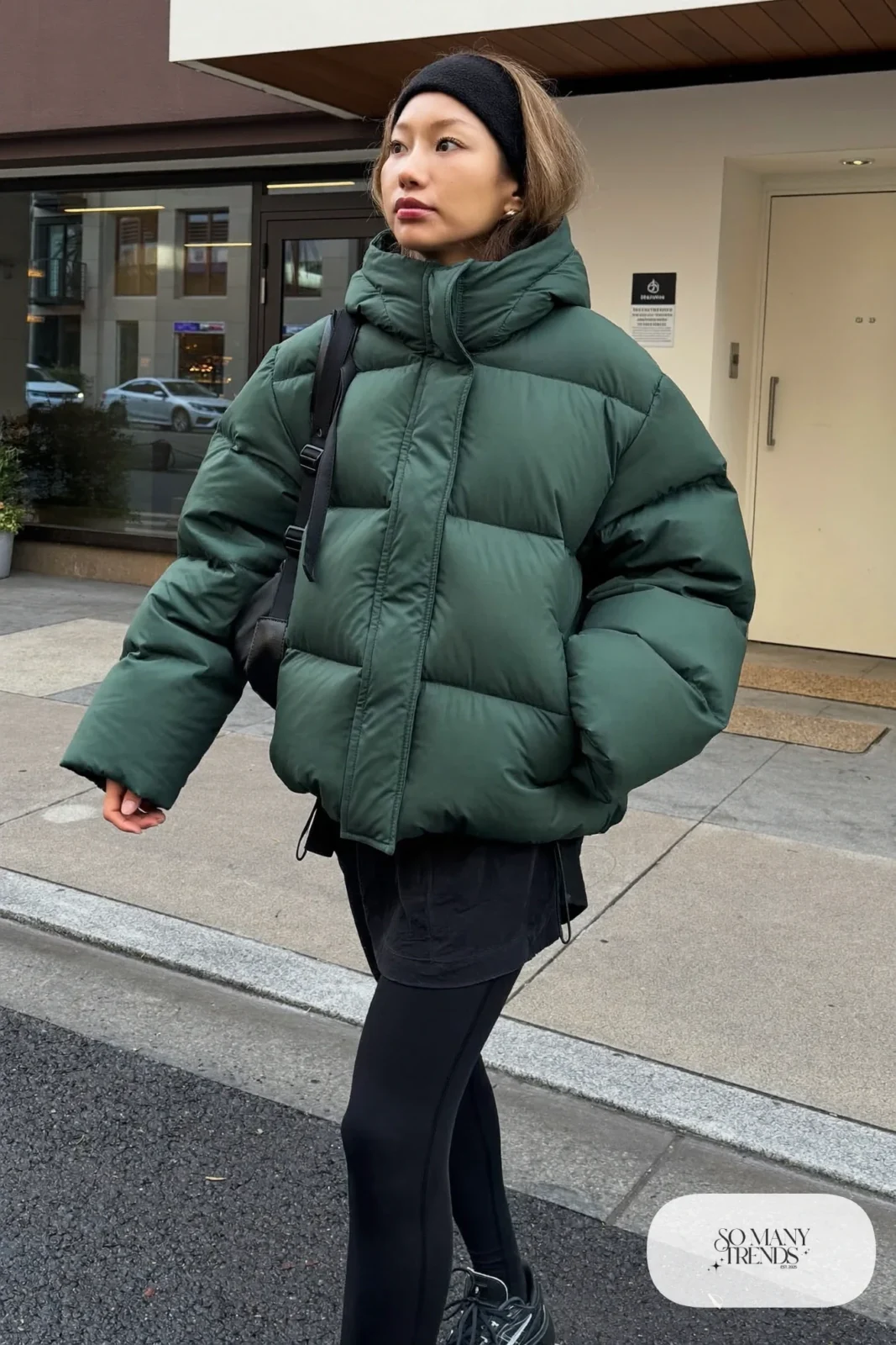 boxy forest green puffer jacket long black tee black leggings black sneakers headband small backpack january outfit 19