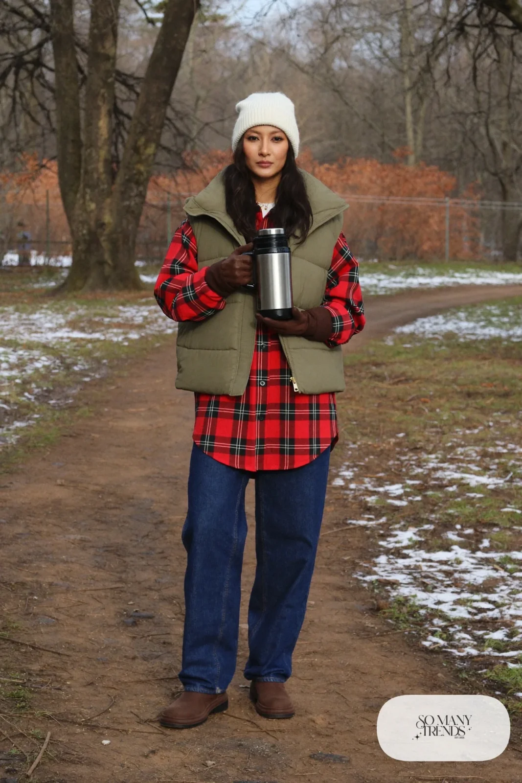 red and black plaid flannel shirt olive quilted vest straight indigo jeans brown boots cream beanie thermos january outfit 26