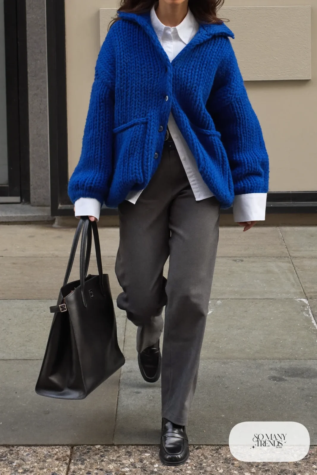 cobalt blue chunky cardigan white button-up shirt gray straight pants black loafers black belt leather tote january outfit 29