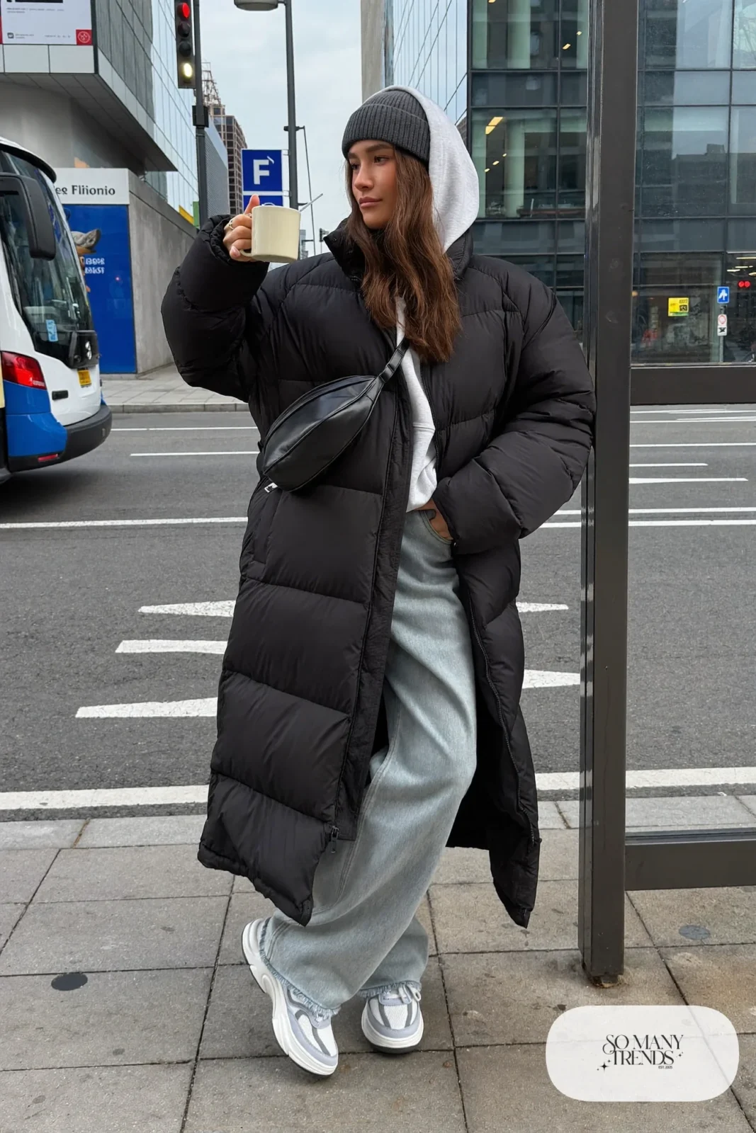 Long black matte puffer coat, gray hoodie, loose blue jeans, chunky sneakers, beanie, crossbody bag, winter outfit 7