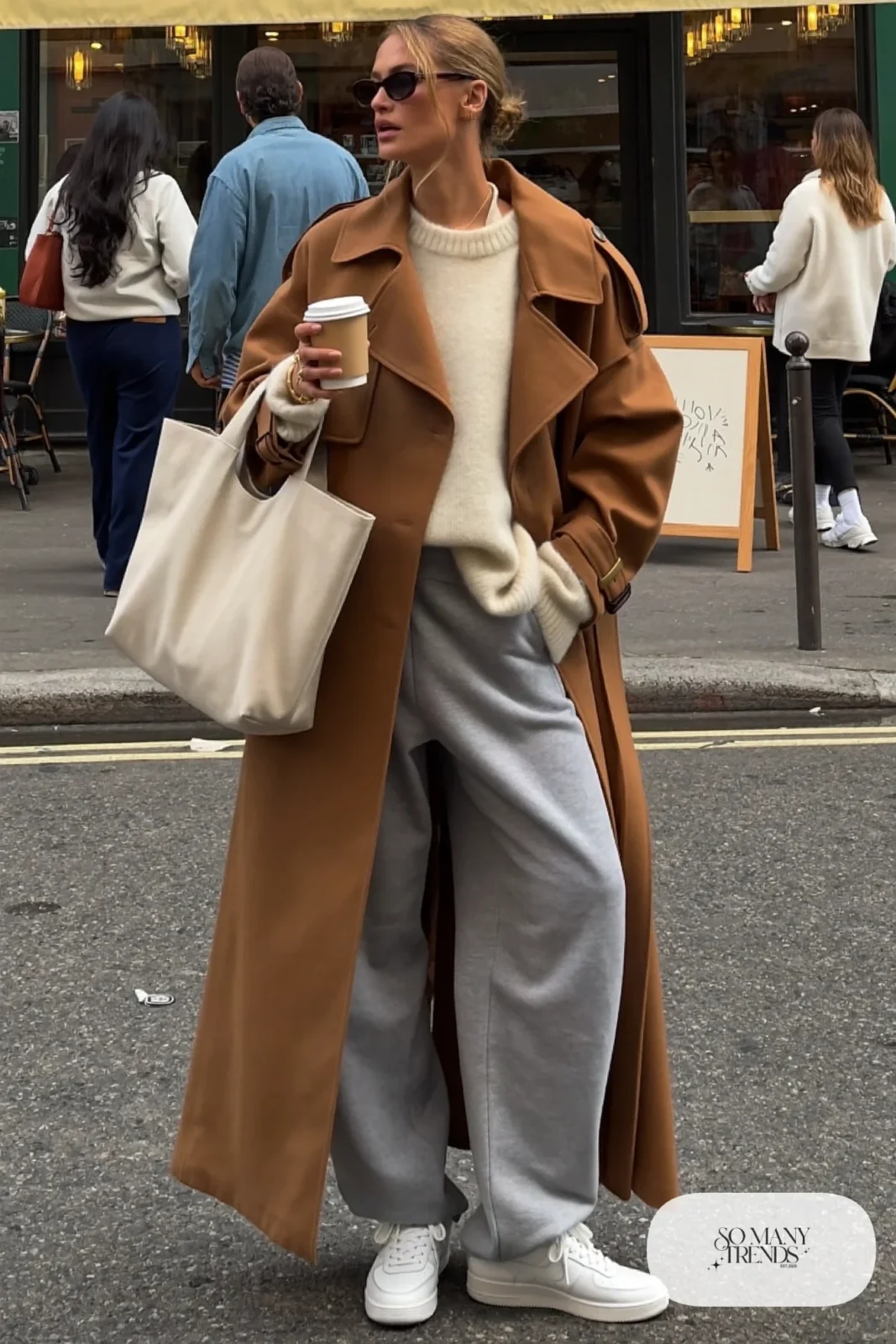 Camel belted trench coat, cream sweater, gray straight sweatpants, clean sneakers, tote bag, winter outfit 17