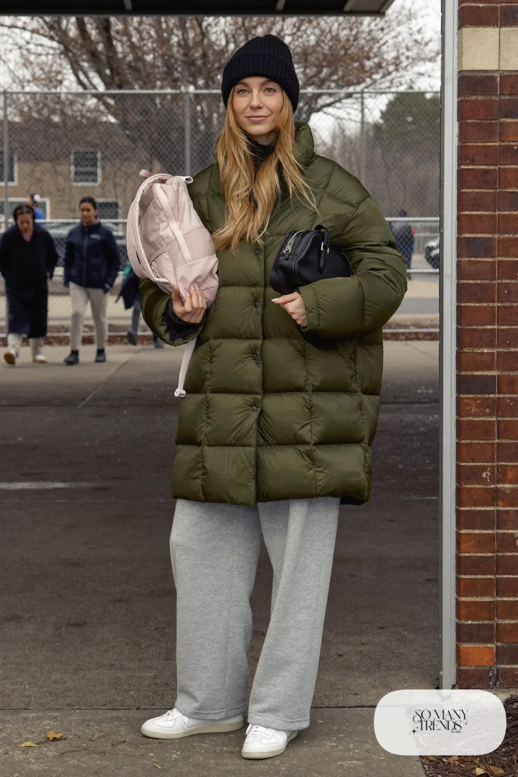 olive green oversized puffer jacket gray wide leg sweatpants white leather sneakers black beanie crossbody bag outfit 2