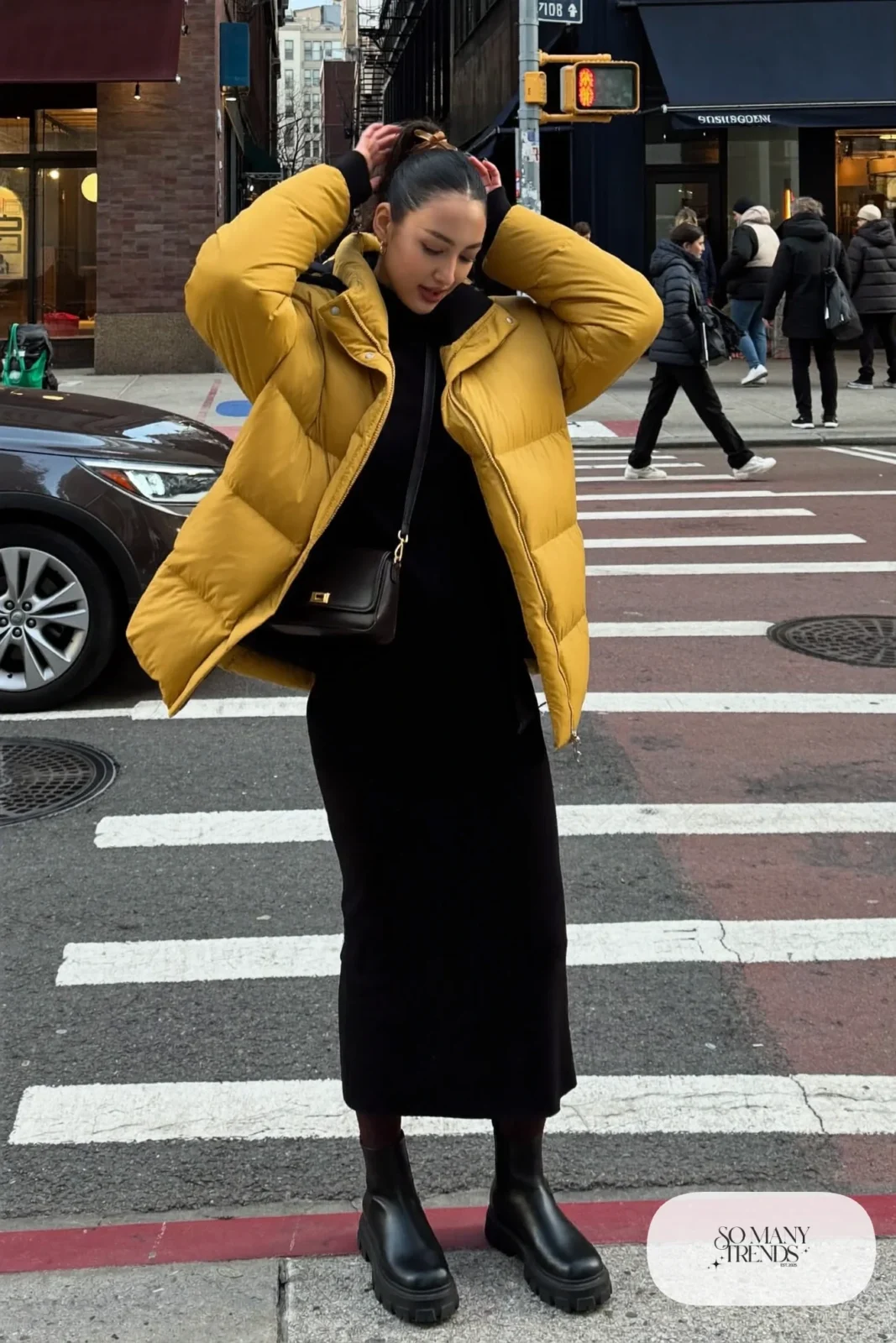 mustard yellow cropped puffer jacket black long sleeve knit midi dress black chunky lug sole boots black tights crossbody bag outfit 10