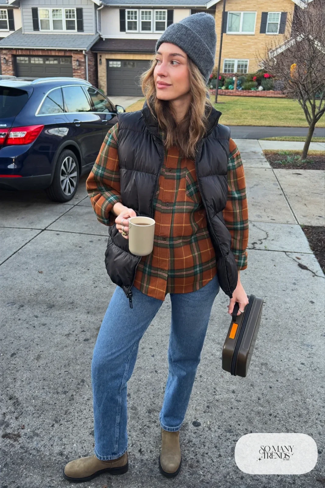 black puffer vest rust green plaid flannel shirt straight jeans brown ankle boots gray beanie tote bag outfit 13