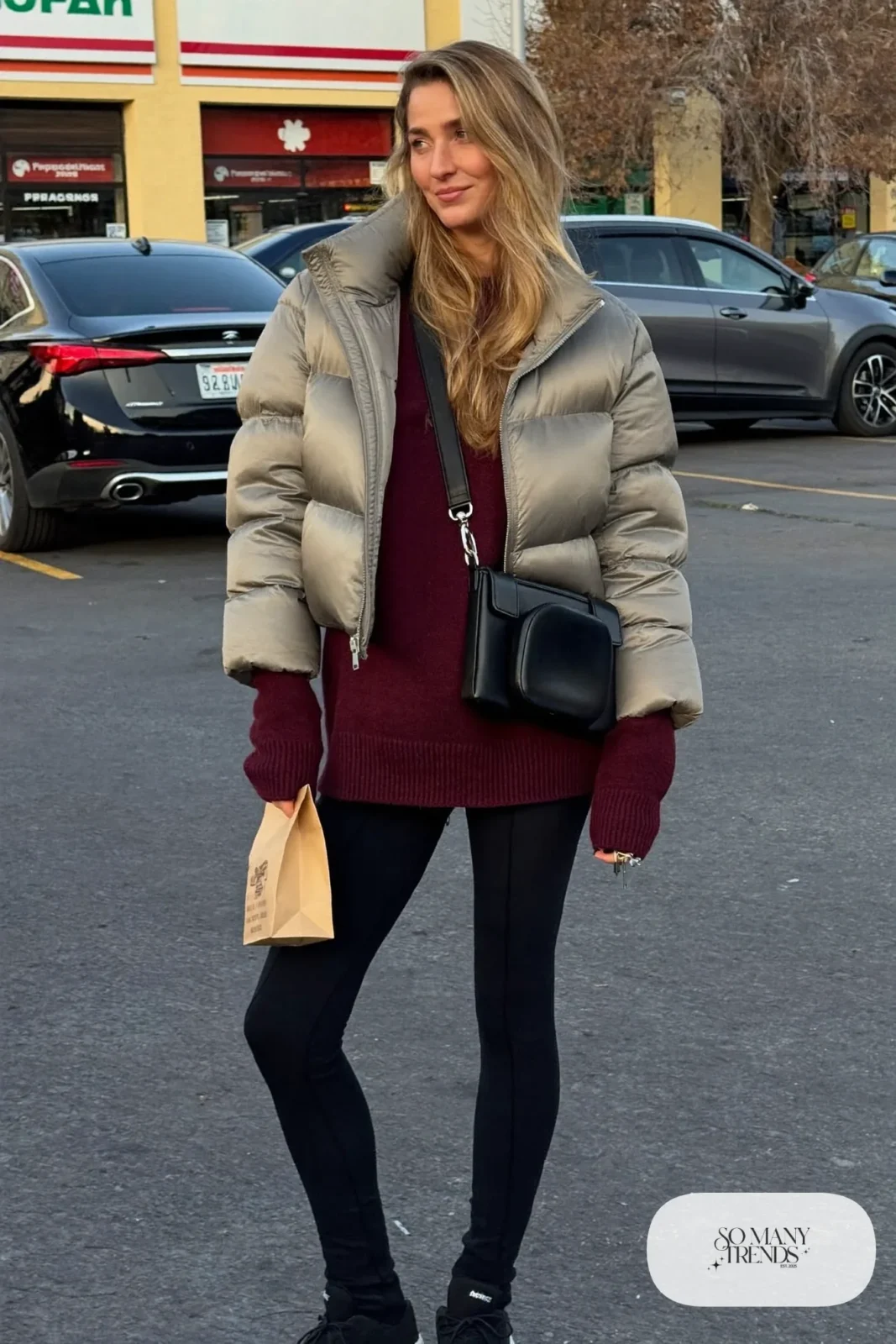 gray matte puffer jacket burgundy knit sweater thick black leggings black sneakers black crossbody bag outfit 29