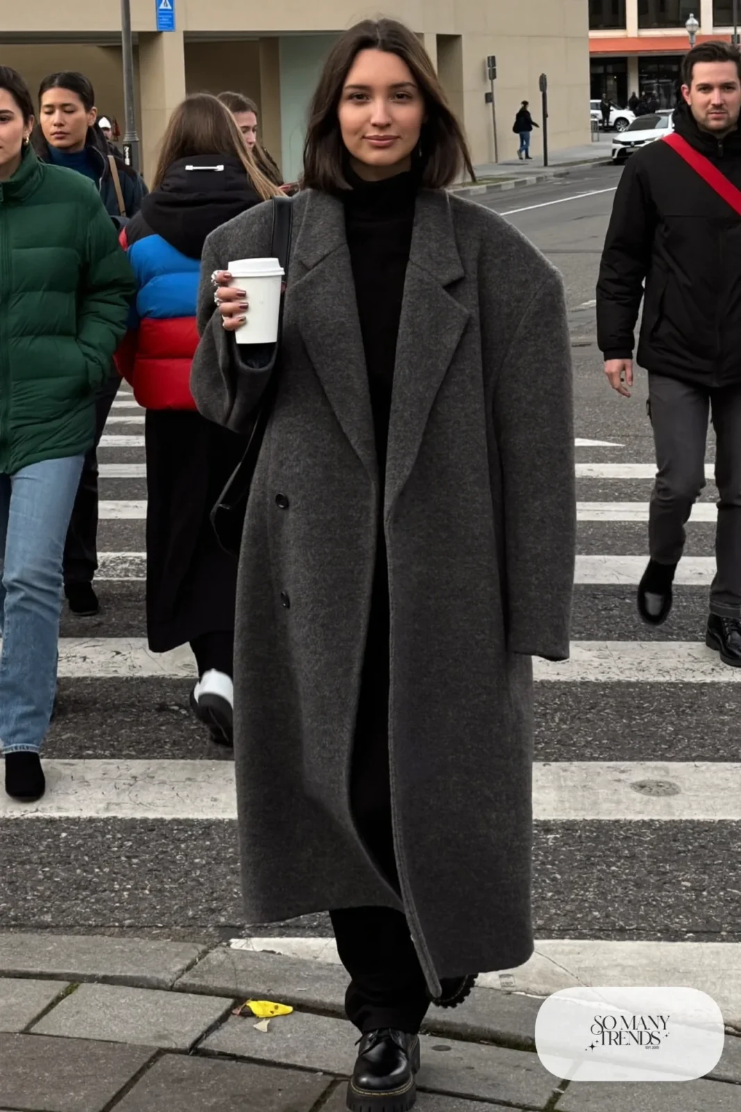 long charcoal gray wool coat black turtleneck black straight pants black leather boots silver rings outfit 5