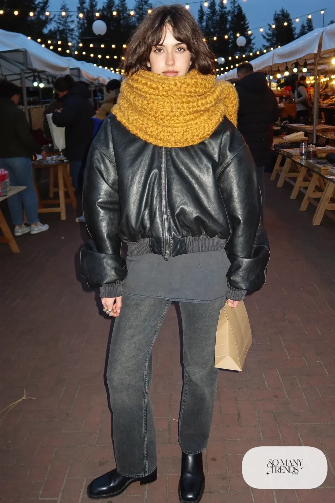 chunky mustard yellow scarf black leather jacket charcoal tee dark straight jeans black boots outfit 15