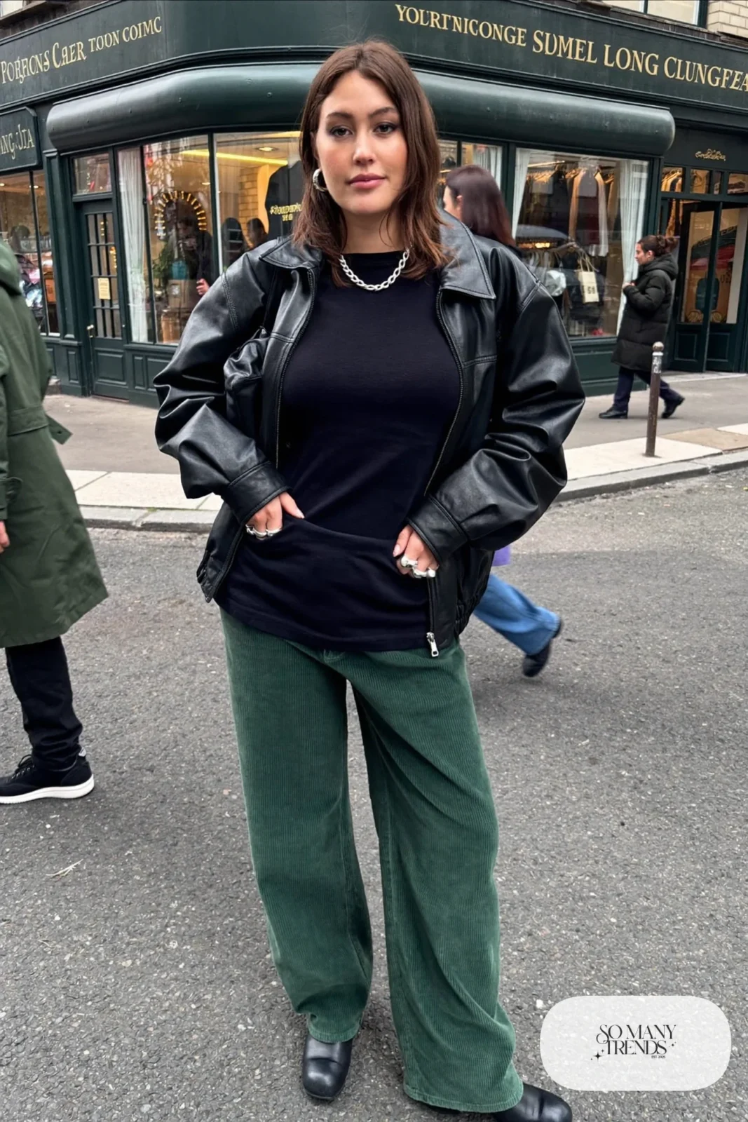 wide-leg forest green pants black leather jacket black tee black boots silver chain outfit 23