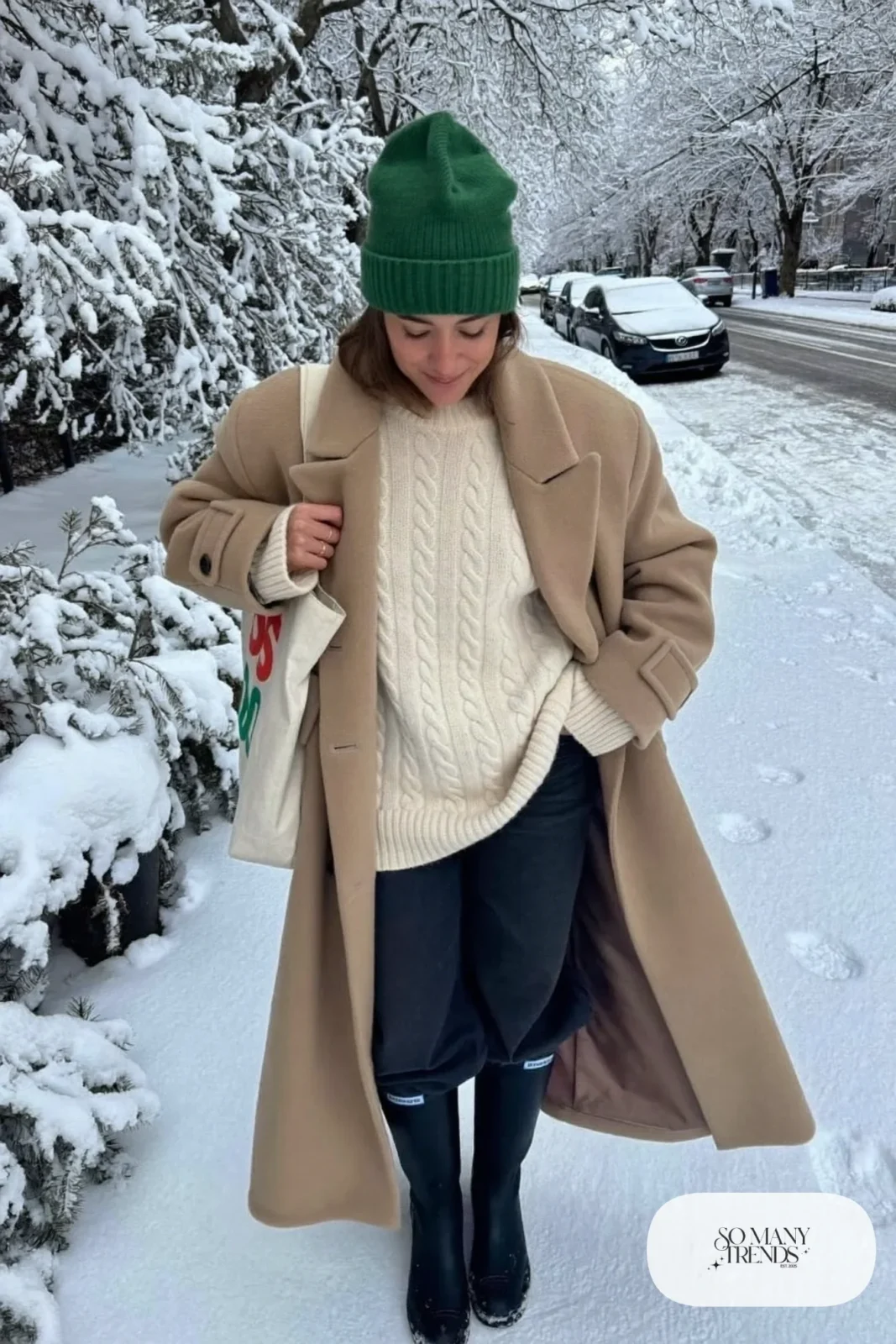 camel long wool coat cream fisherman sweater forest green beanie wide-leg jeans tall winter boots tote bag outfit 2