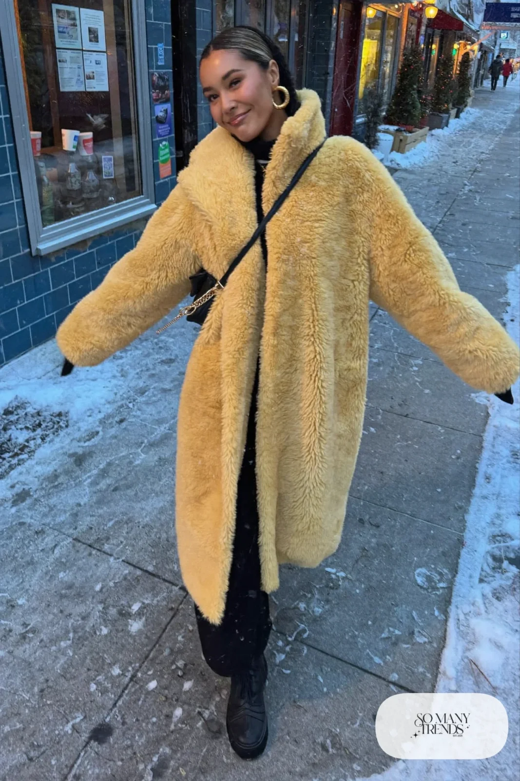 butter yellow faux shearling coat black turtleneck black wide-leg fleece-lined pants chunky waterproof boots gold earrings outfit 31