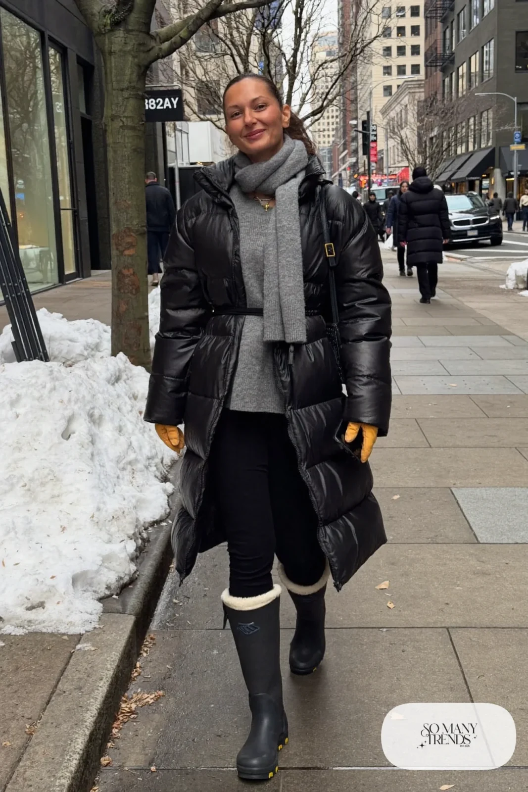 black belted long puffer coat gray sweater black thermal leggings tall boots mustard gloves outfit 4