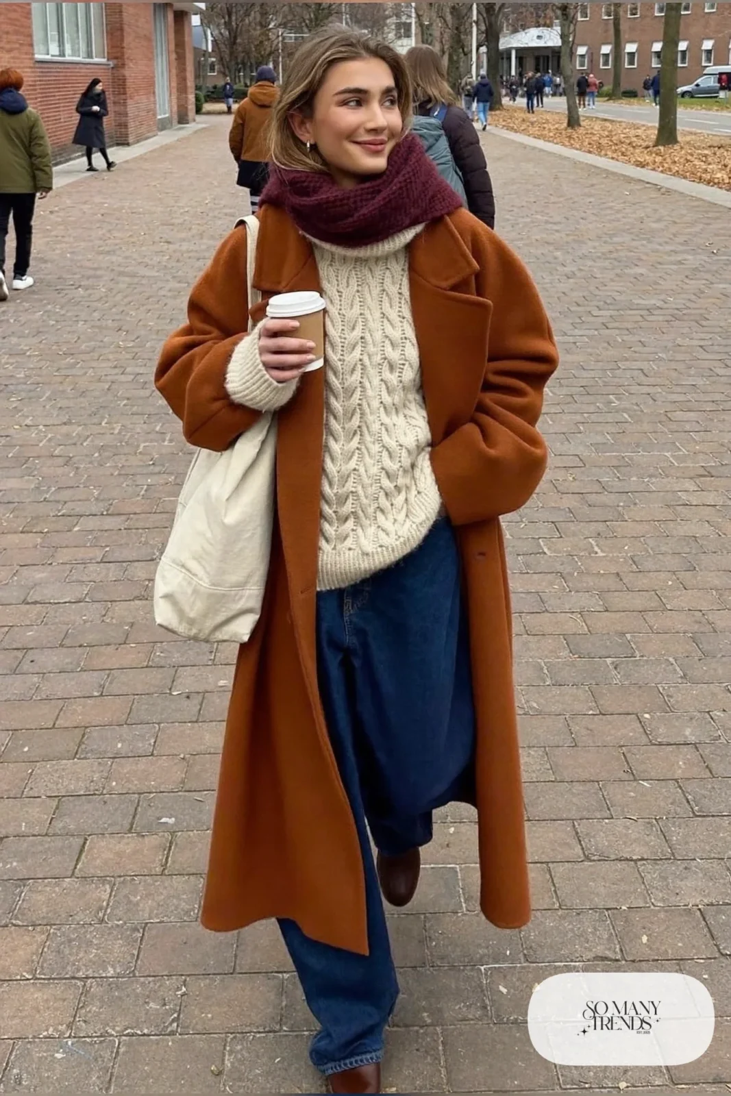 oversized rust wool coat cream cable-knit sweater wide-leg dark jeans brown ankle boots burgundy scarf outfit 1