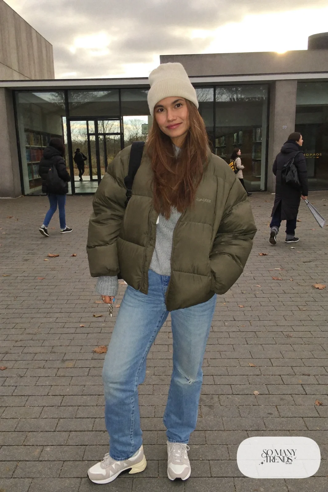 boxy olive puffer jacket gray knit sweater straight jeans white sneakers cream beanie outfit 2