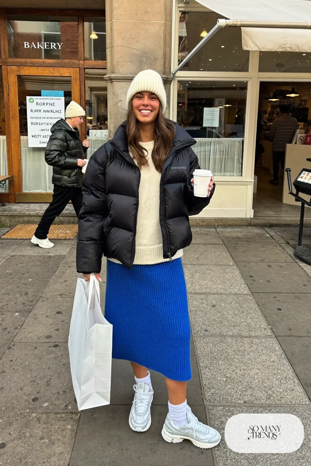 cobalt knit midi skirt cropped black puffer jacket cream sweater white sneakers beanie outfit 17