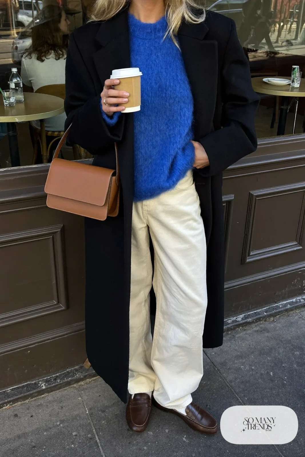 cobalt blue knit sweater cream wide-leg pants long black coat brown loafers shoulder bag outfit 20