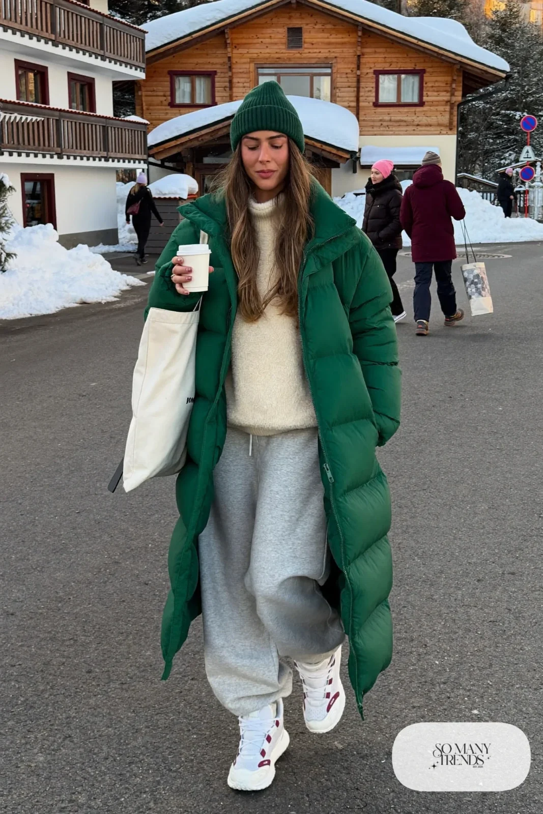 long forest green puffer coat cream fleece pullover gray wide-leg joggers white sneakers tote bag outfit 1