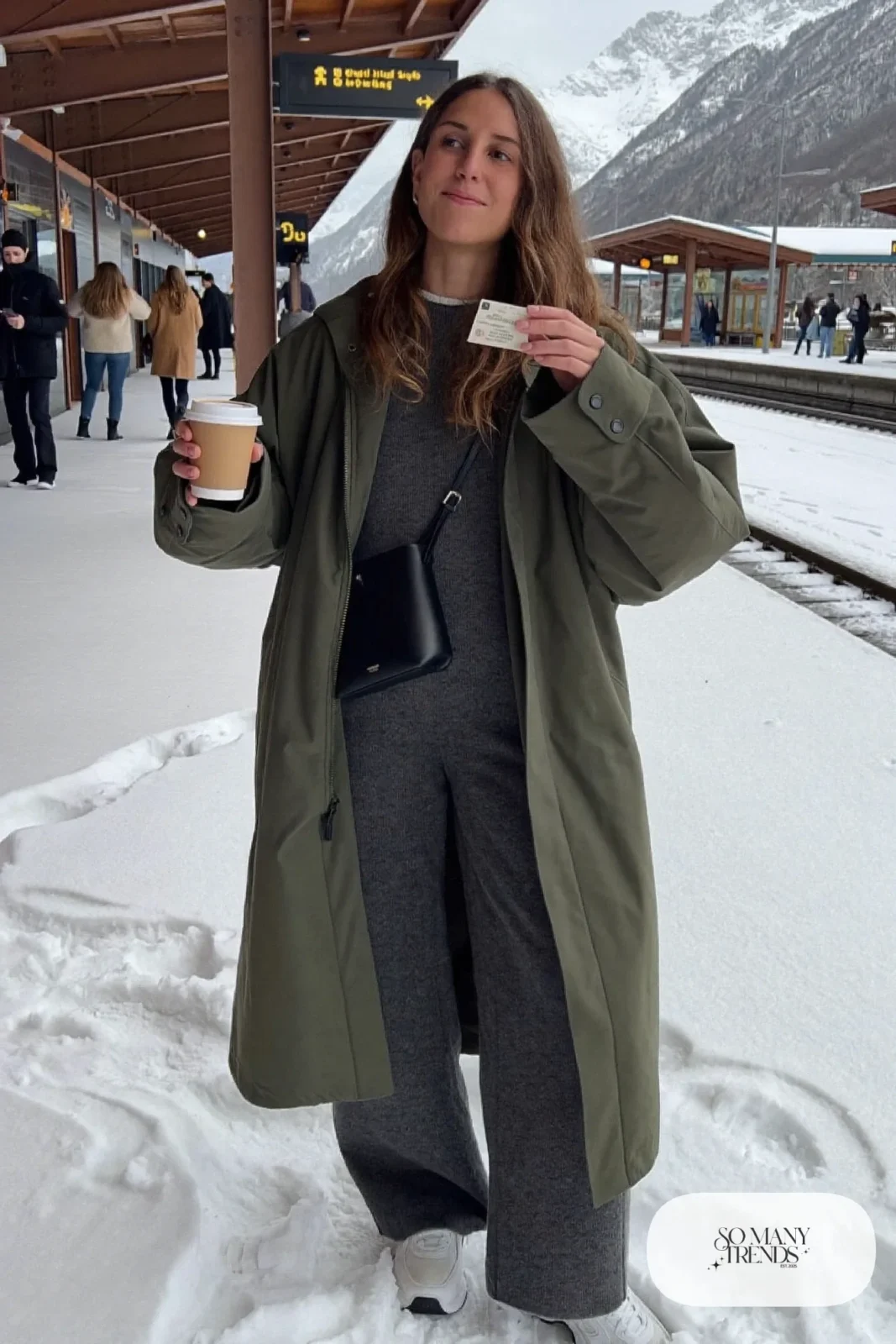 charcoal knit jumpsuit olive parka white sneakers crossbody bag outfit 32