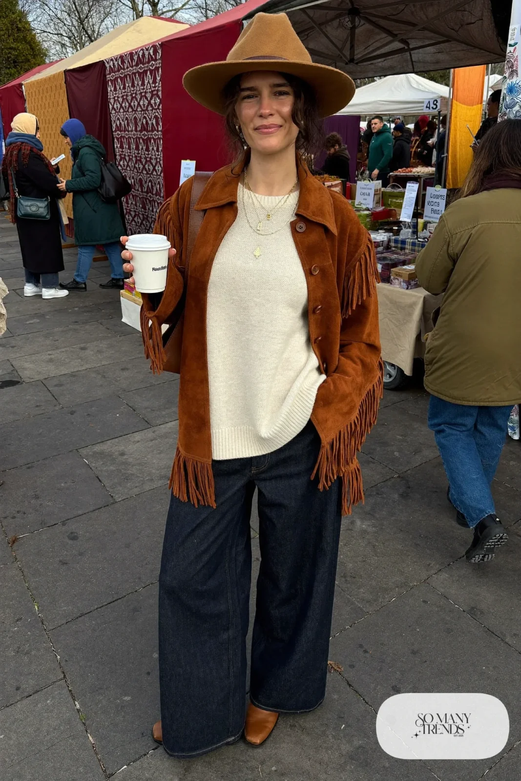 rust suede fringe jacket cream sweater wide-leg dark jeans brown ankle boots felt hat outfit 1