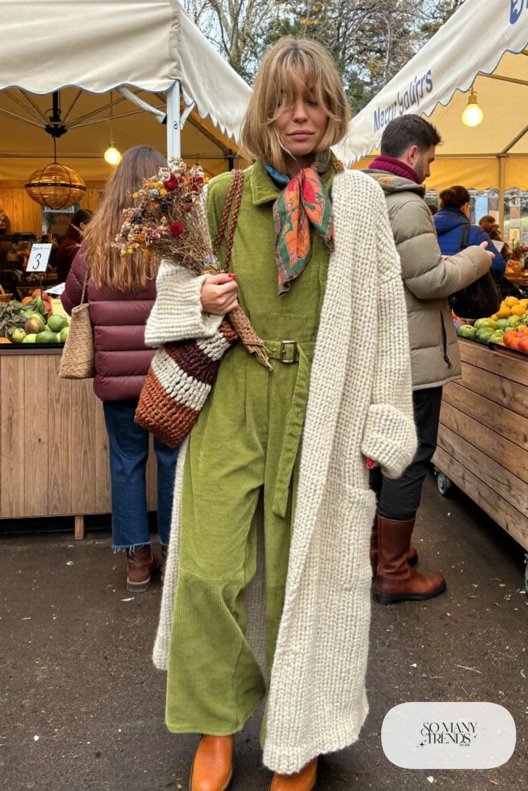olive corduroy jumpsuit cream chunky cardigan tan ankle boots printed scarf woven bag outfit 28