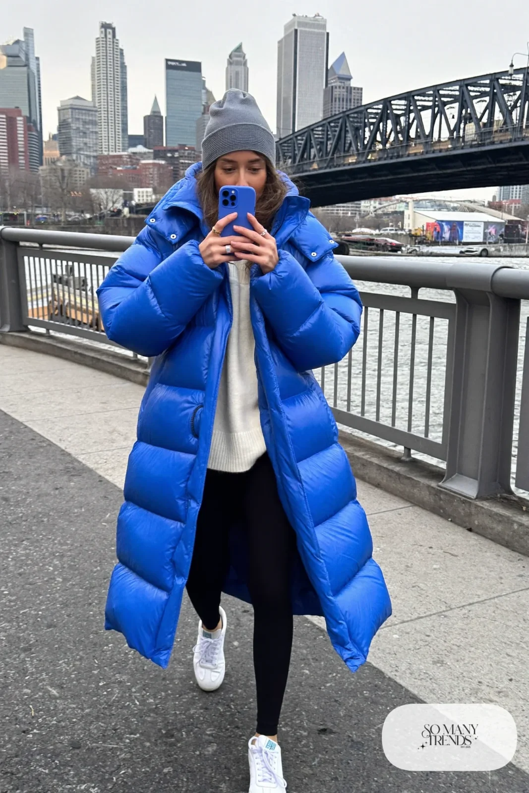 long cobalt puffer coat black leggings cream sweater white sneakers beanie nashville outfit 23