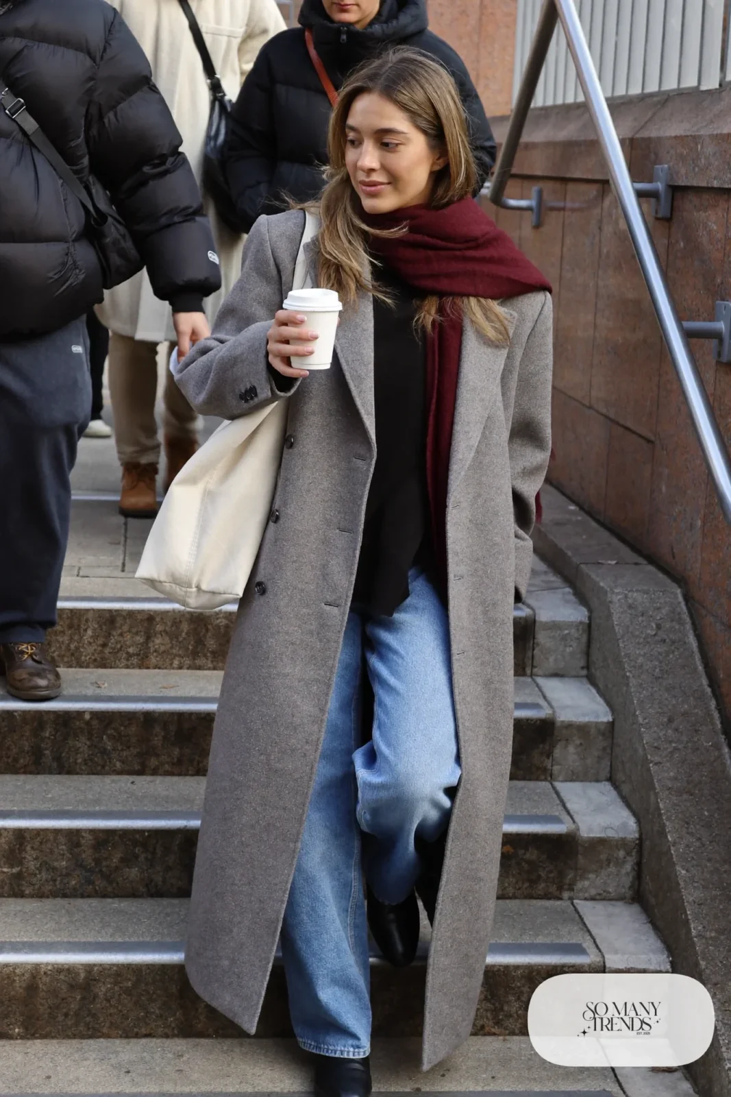 long gray wool coat, black knit top, wide-leg medium blue jeans, burgundy scarf, black boots outfit 6