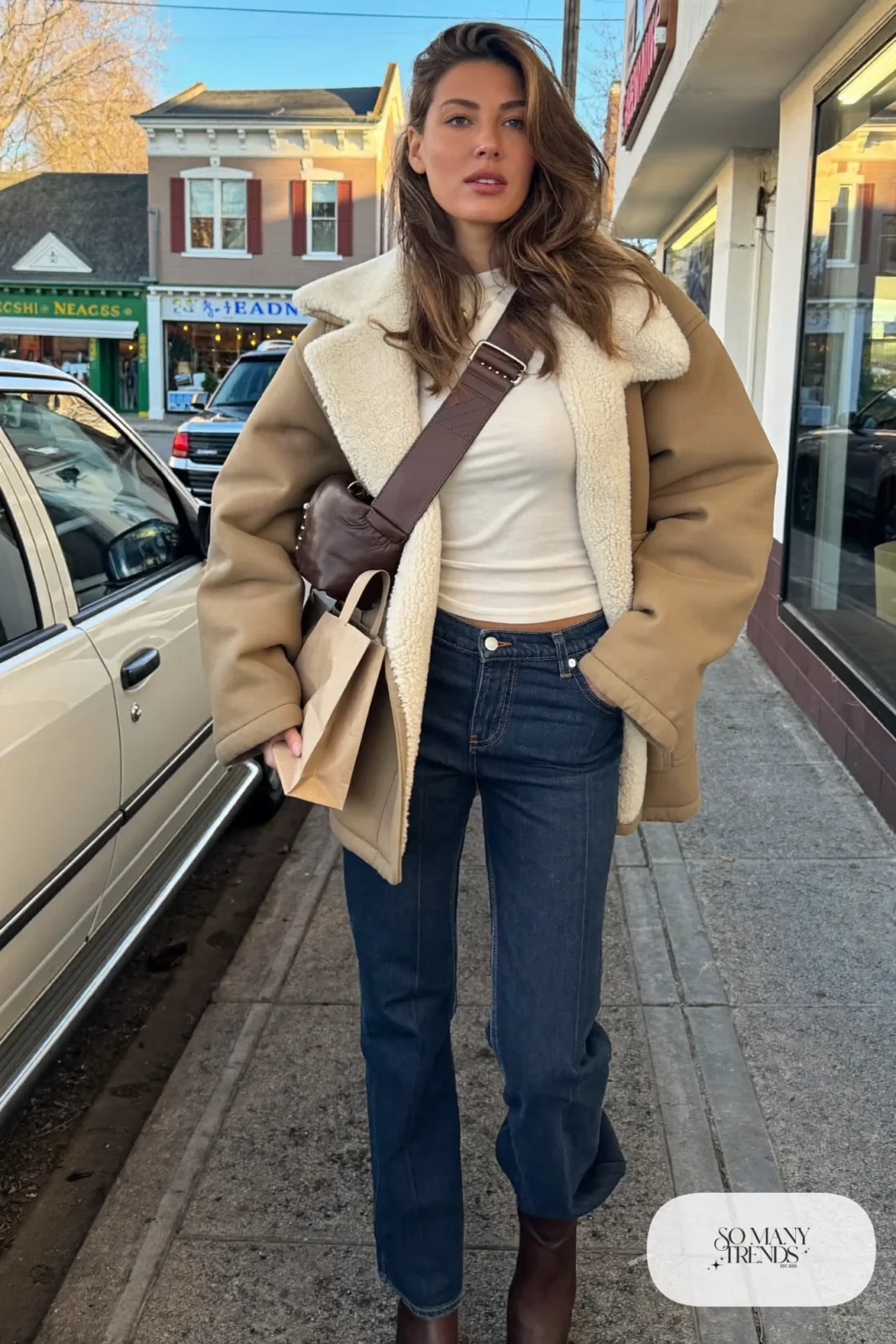 tan shearling-lined jacket, white fitted tee, dark bootcut jeans, brown leather boots, crossbody bag outfit 11