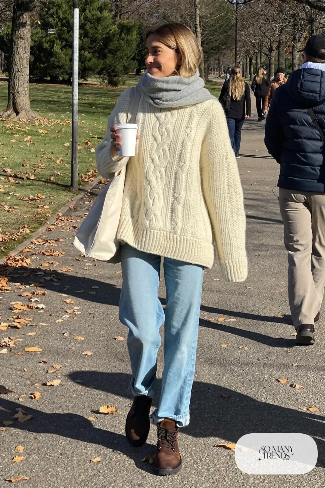 chunky cream fisherman sweater, light-wash cuffed jeans, brown lace-up lug-sole boots, wool scarf, tote bag outfit 22