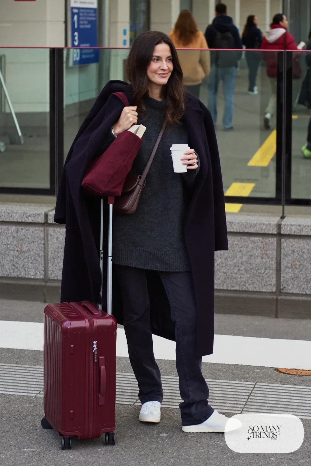 charcoal long sweater dark stretch jeans white sneakers crossbody bag long coat train outfit 26