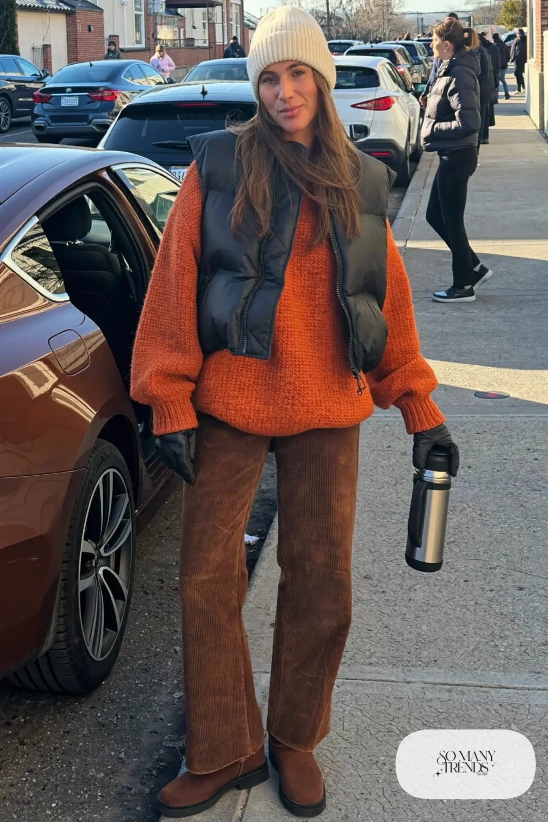 rust long sweater brown corduroy pants beanie suede boots puffer vest thermos outfit 27