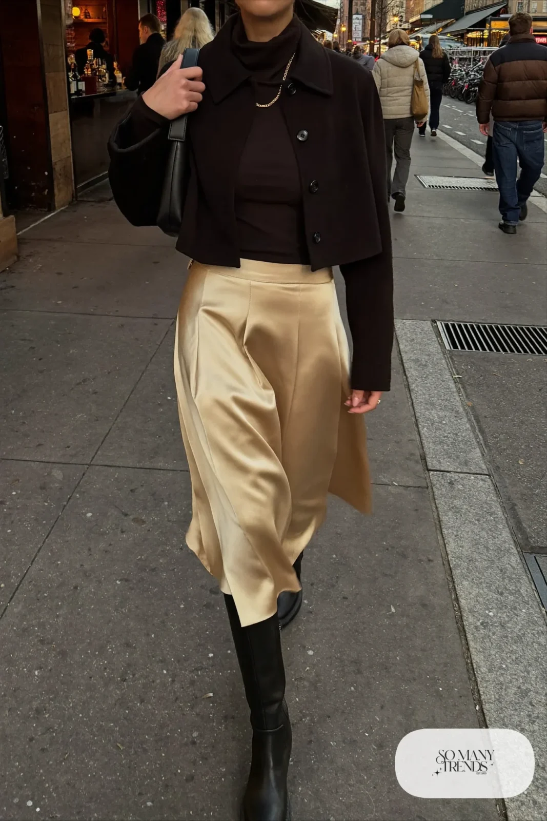 champagne pleated satin midi skirt black fitted turtleneck knee-high boots short black jacket outfit 10